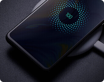 Smartphone resting on a simple charging pad